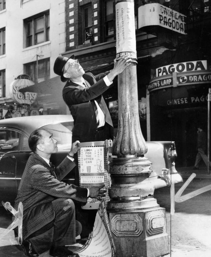 Col. John S. Young and Bernard M. Croty installing an experimental litter basket on Grant Avenue, Chinatown, 1961.