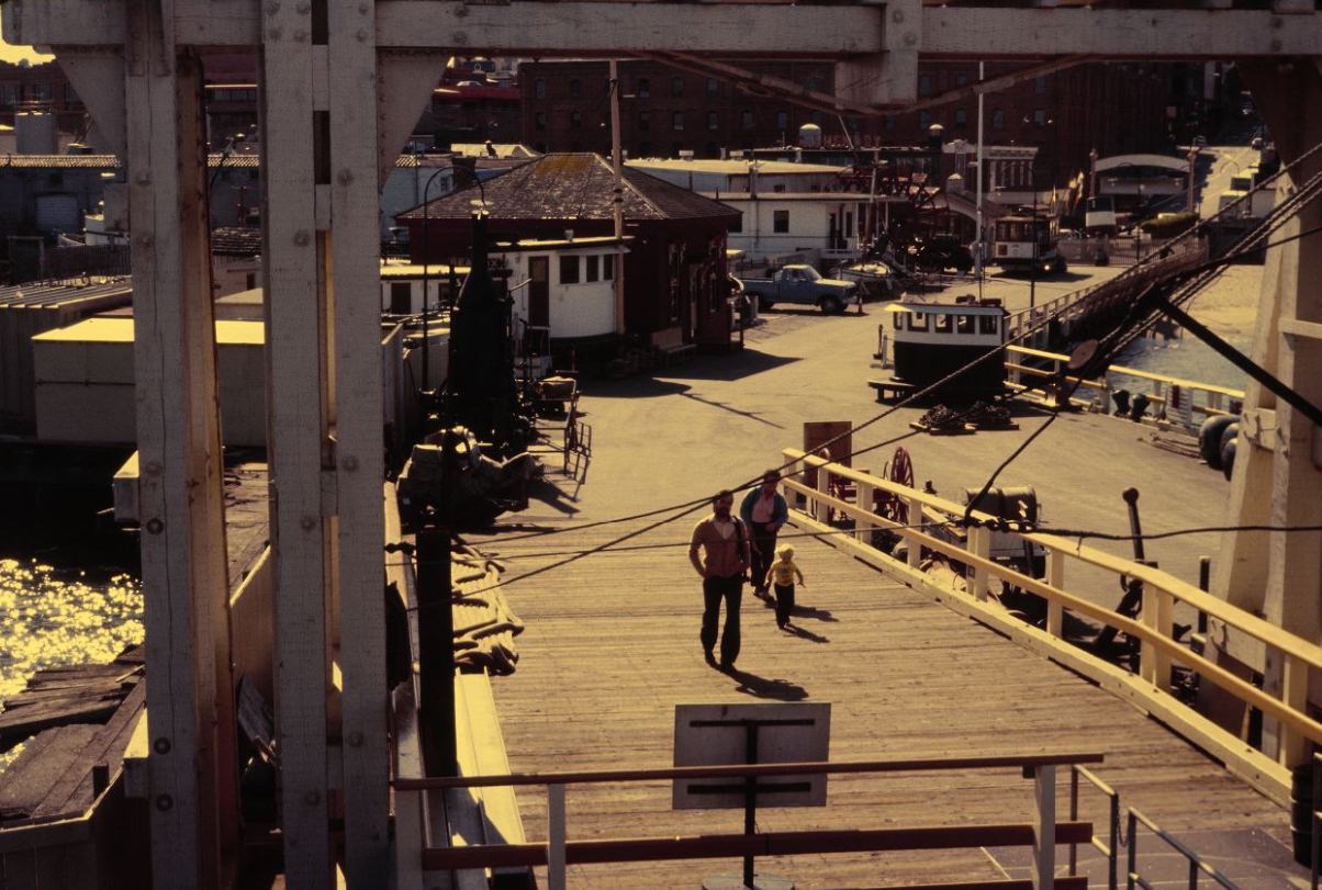 People walking through Hyde Street Pier, 1984.