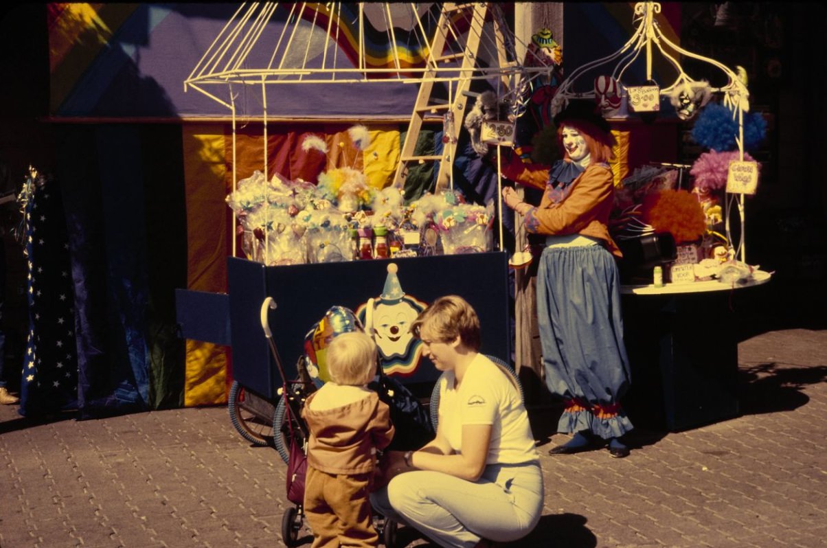 Clown vendor with customers at Pier 39, 1984.