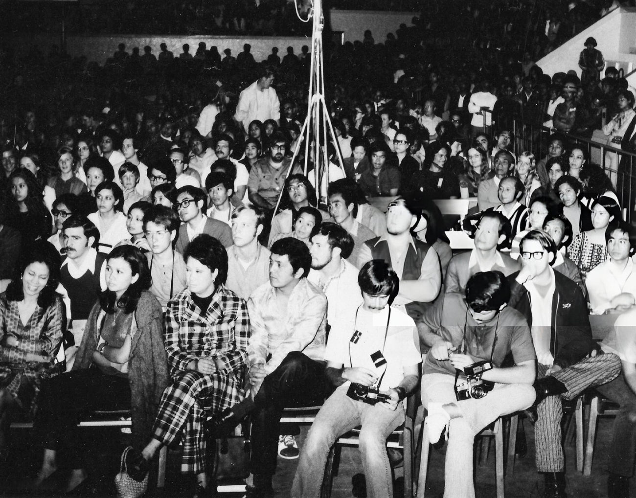 Spectators at Saint Louis University, Baguio City, Philippines, attend an anti-Vietnam War FTA Show in December 1971.
