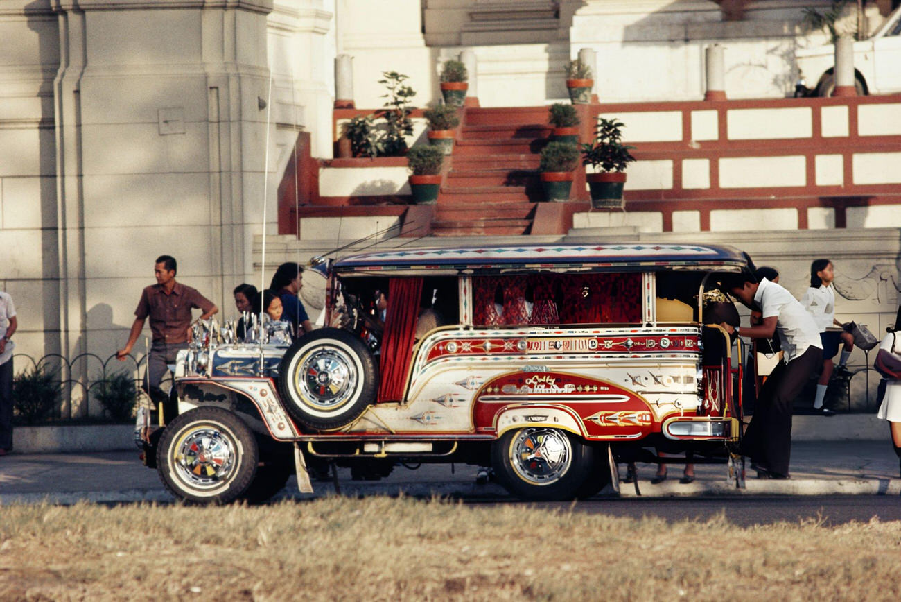 A crowded jeepney picks up passengers in Manila, Philippines, 1974.