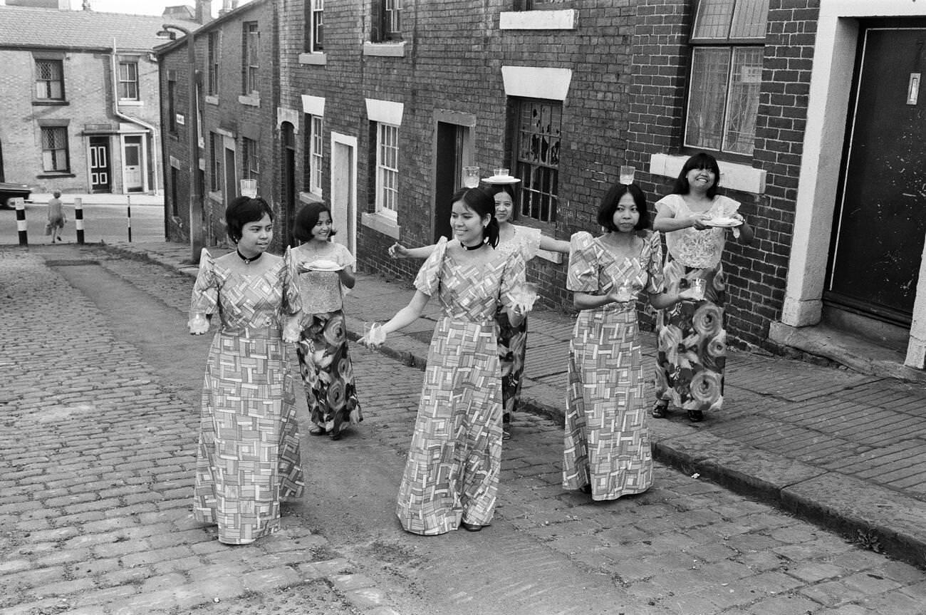 Women from Manila working in a mill in Rochdale, Lancashire, showcasing national dancing on 20th July 1972.