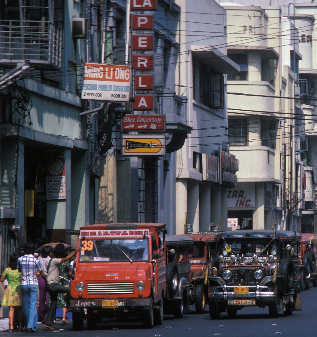 Jeepneys, originally American jeeps modified for public transport, in Manila's streets, December 1977.