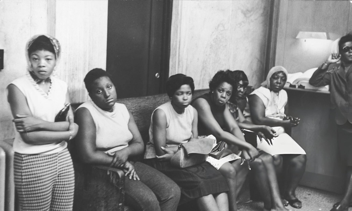 A group of women in a police station as they wait to pick up relatives picked up by police for looting during riots