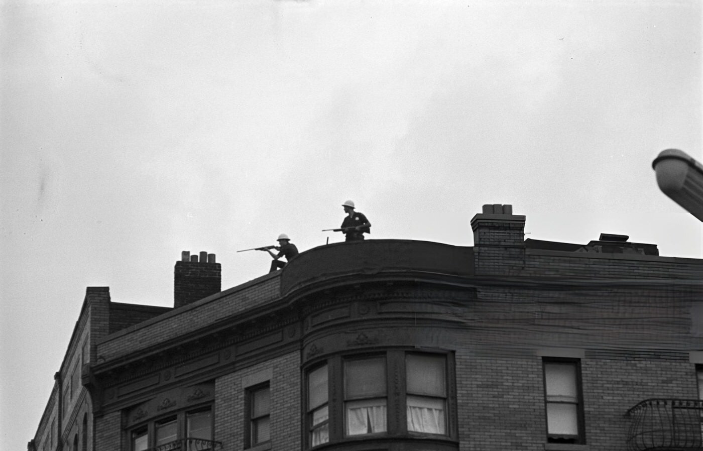 National Guard soldiers on the roof of a building overlooking the streets