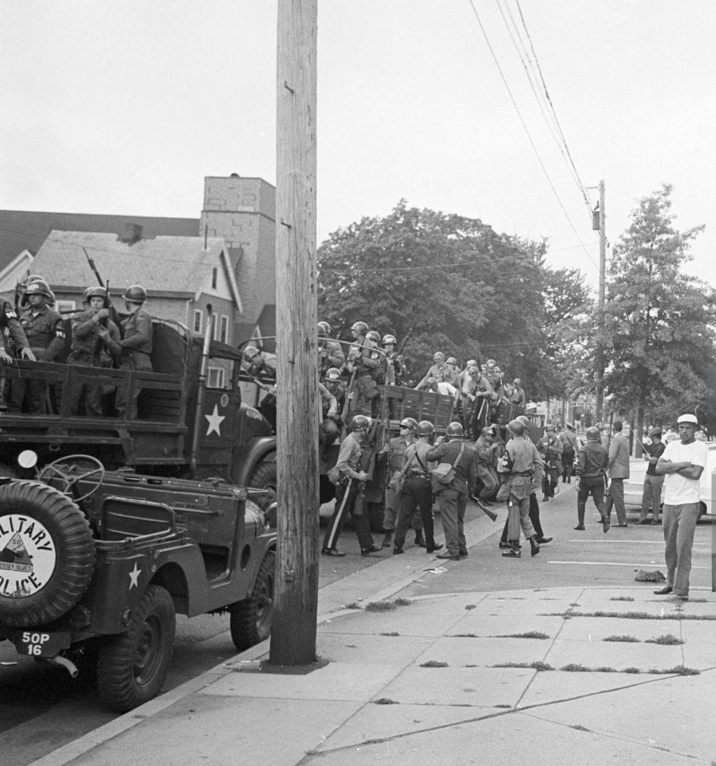 Military jeeps and trucks occupied by soldiers of the federal guard on an avenue