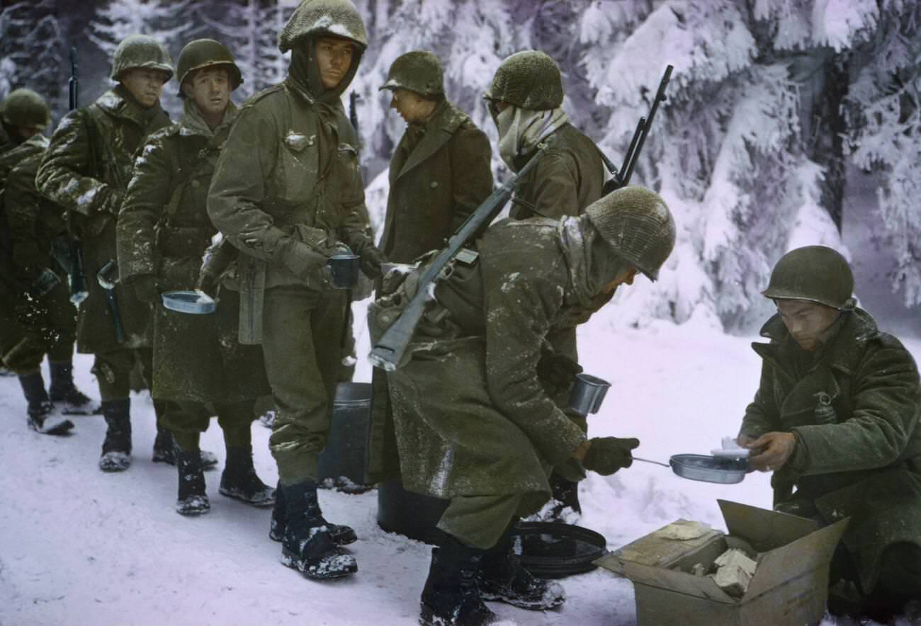 Soldiers receiving food at a field mess, 1945.