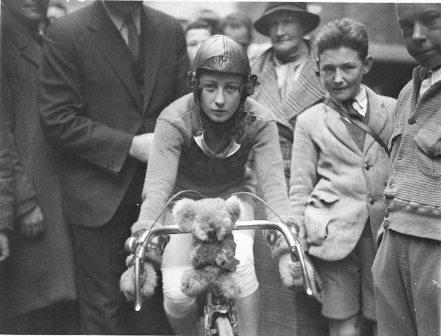 A close-up of Billie Samuels on the Malvern Star bike showing her koala bear mascot before leaving for Melbourne, 1934.