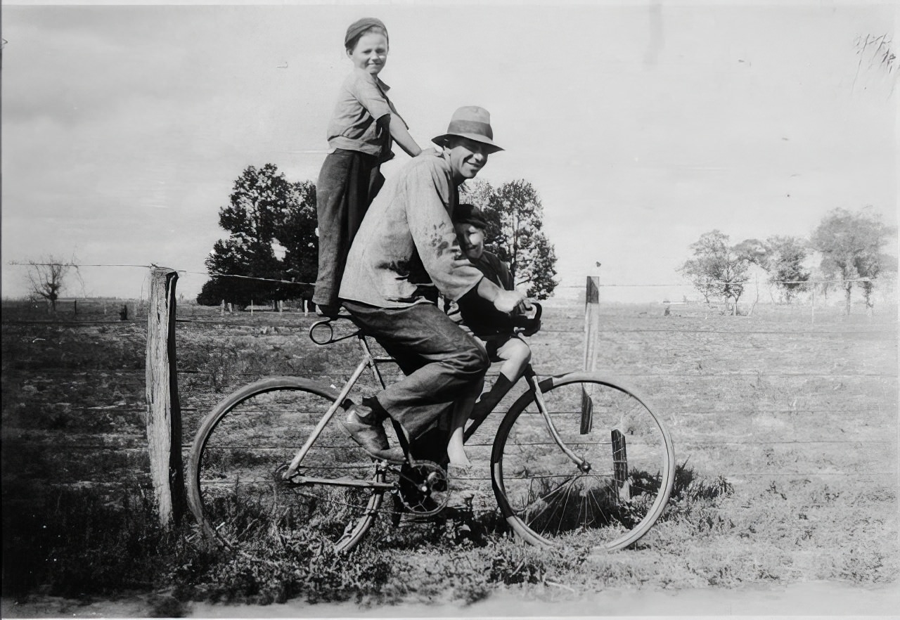 A man on a bicycle pillioning a boy, .