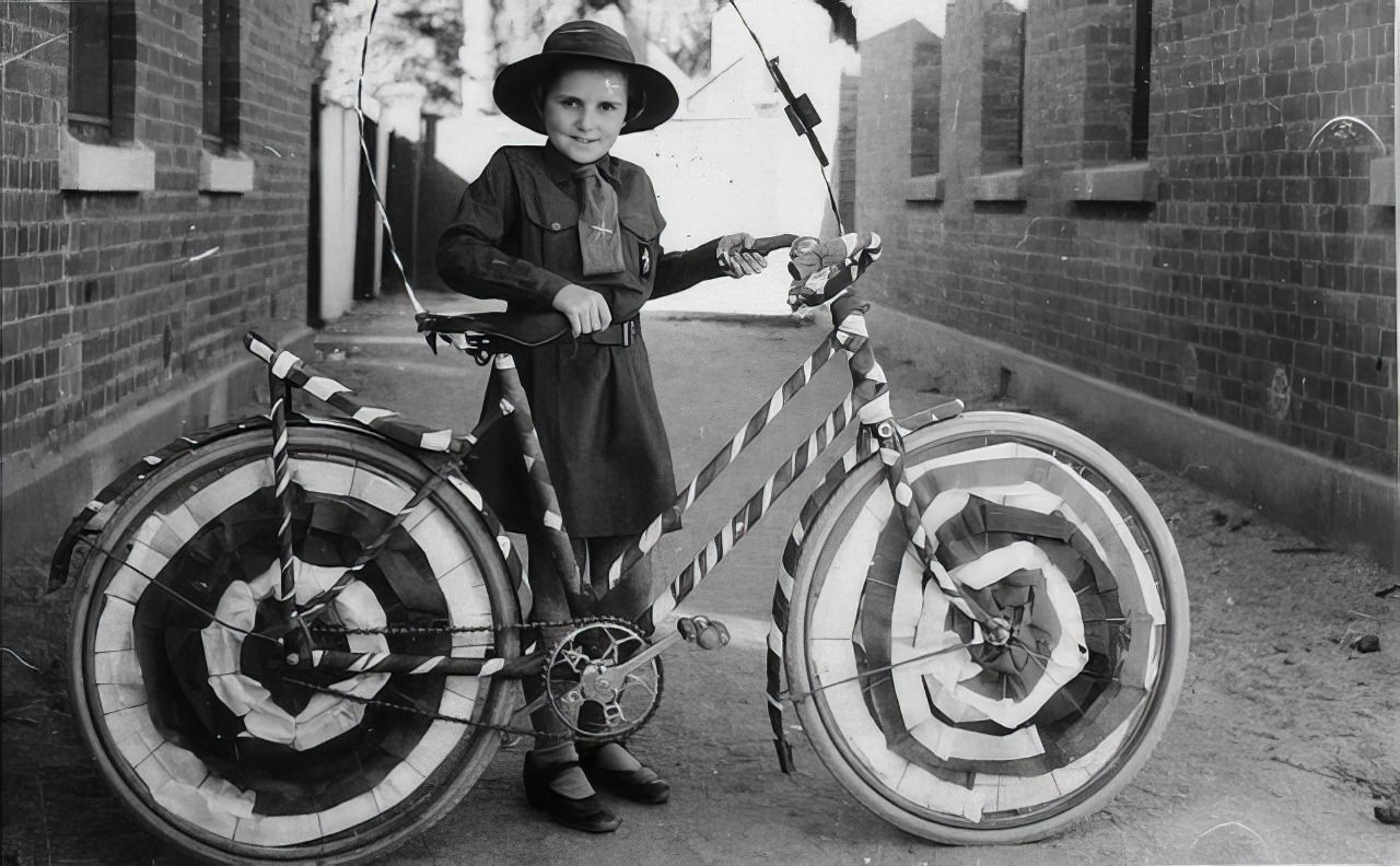 Brownie (Muriel Long) with a bicycle decorated for a street procession, .