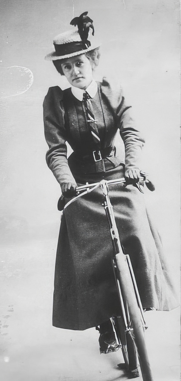Studio photograph of Annie Dawson Wallace seated on a bicycle, 1899.