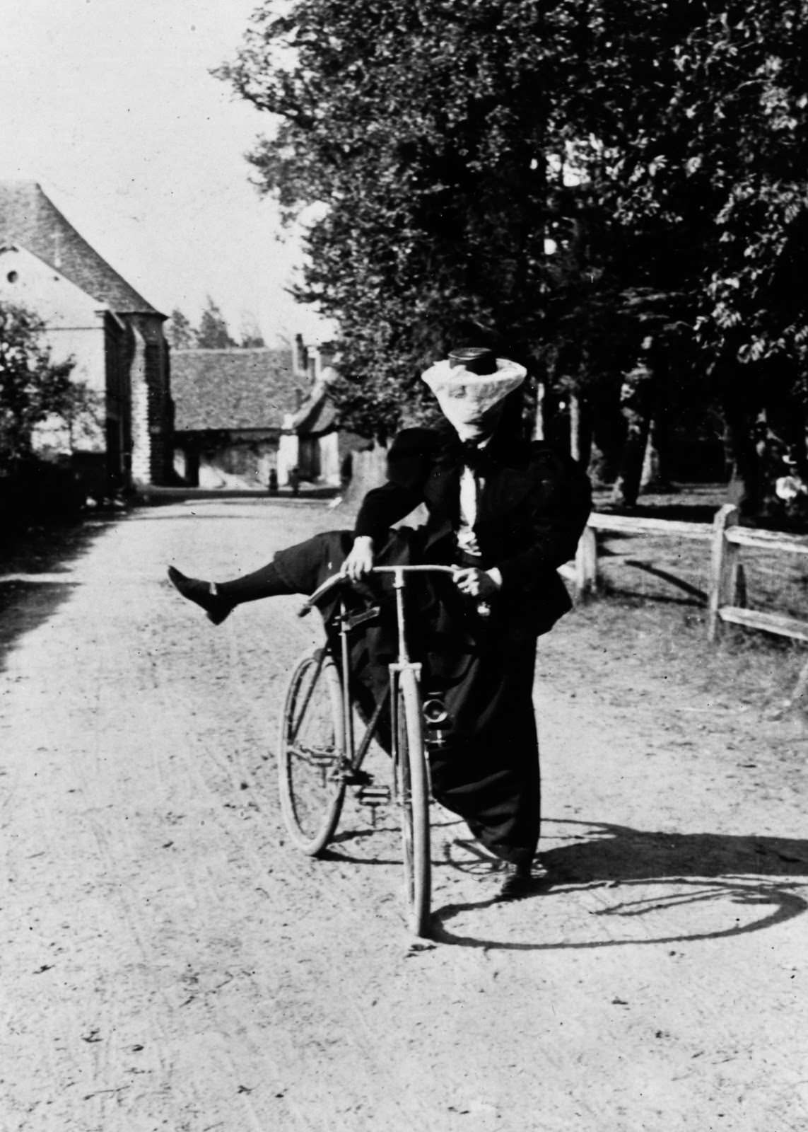 A lady mounts a safety bicycle, 1890.