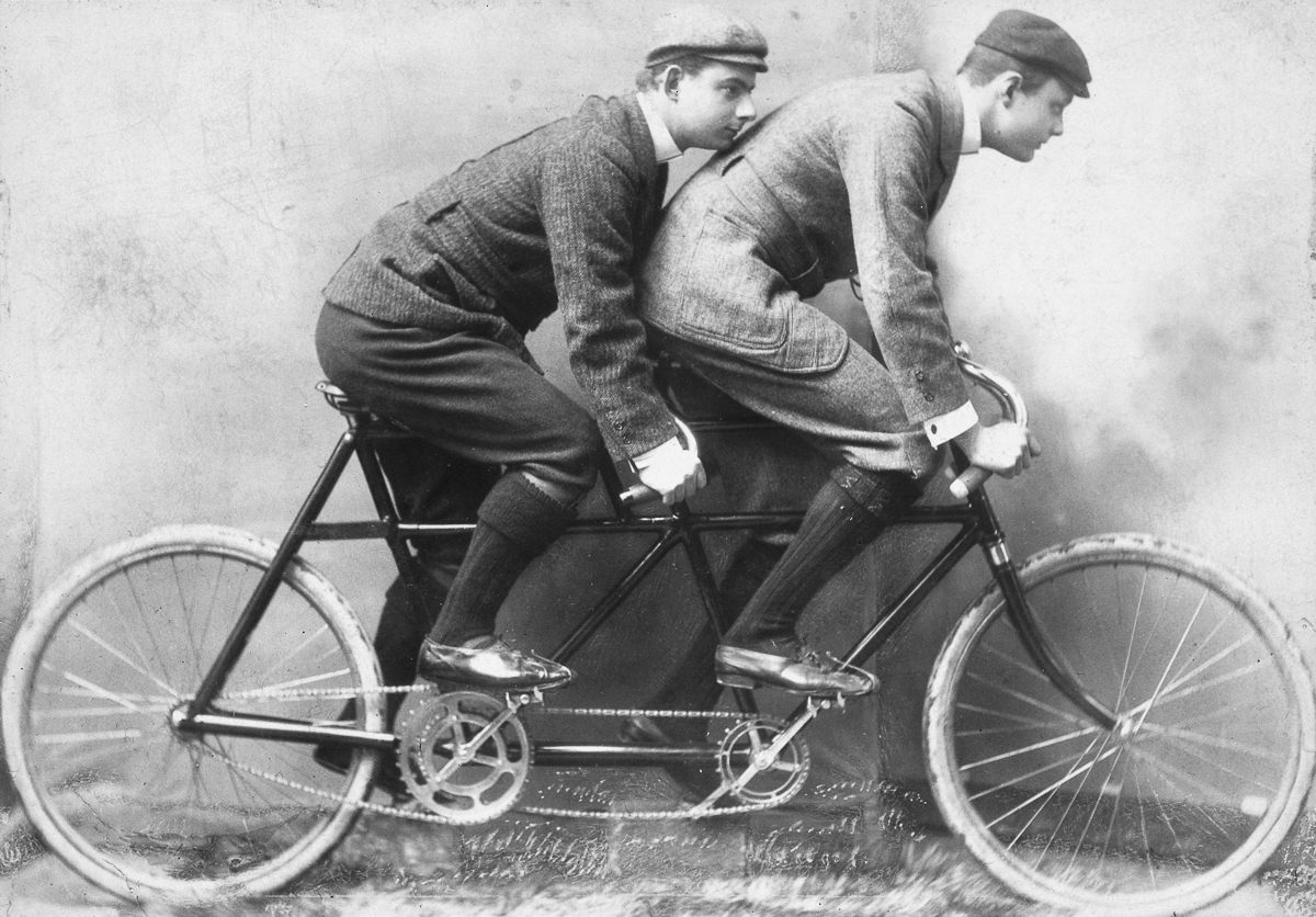 Charles Stewart Rolls, cofounder of Rolls-Royce, rides a tandem bicycle with a fellow Cambridge University student, 1895.