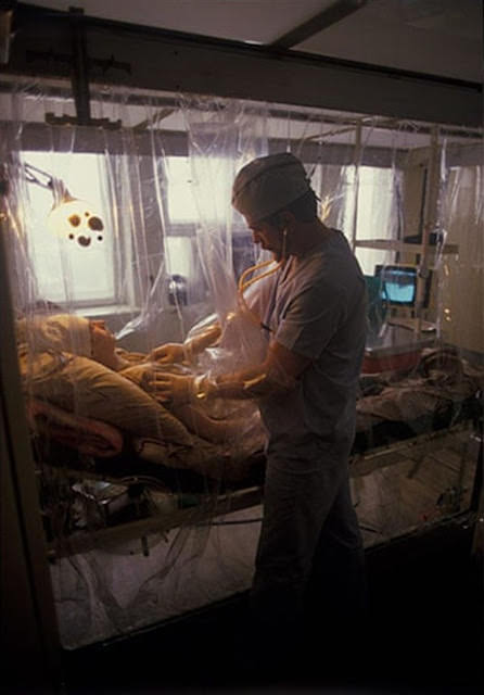 In a specialist radiation unit in Moscow, a liquidator is examined by a doctor in a sterile, air-conditioned room after an operation, January 1987.