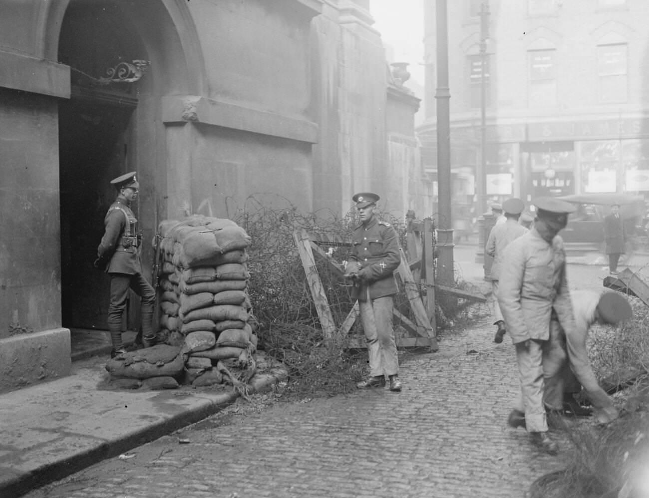The Provisional Government of Southern Ireland takes over control of Dublin Castle with troops removing the barbed wire from an approach to the castle, 1922.
