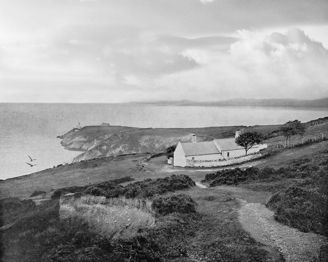 Dublin Bay from Howth Head with cottages and a distant Baily Lighthouse A new tower, 41 metres (134 ft) above the sea, designed by George Halpin Senior, the corporation's Inspector of Works, was completed on 17 March 1814.