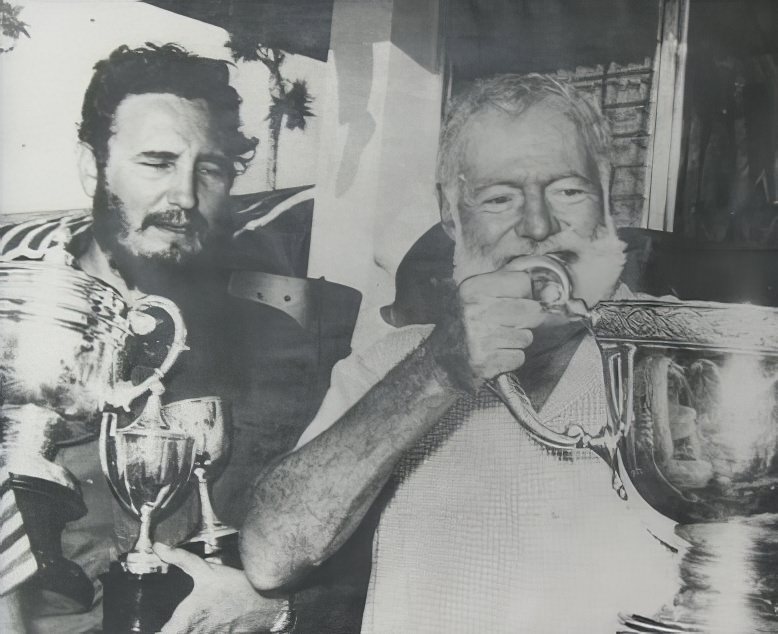 Hemingway and Fidel Castro partying at a fishing tournament in 1960. Castro won the trophy for the largest marlin