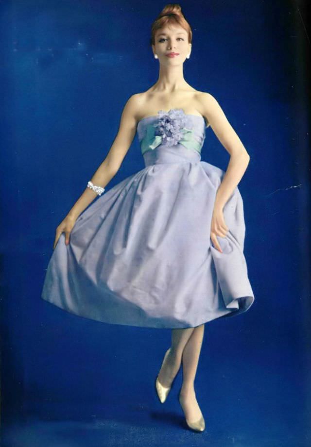 Gunila in a lovely pale lilac velvet dress, the strapless bodice is wrapped in pale green faille ribbon with a corsage of violets, by Pierre Balmain, 1958.