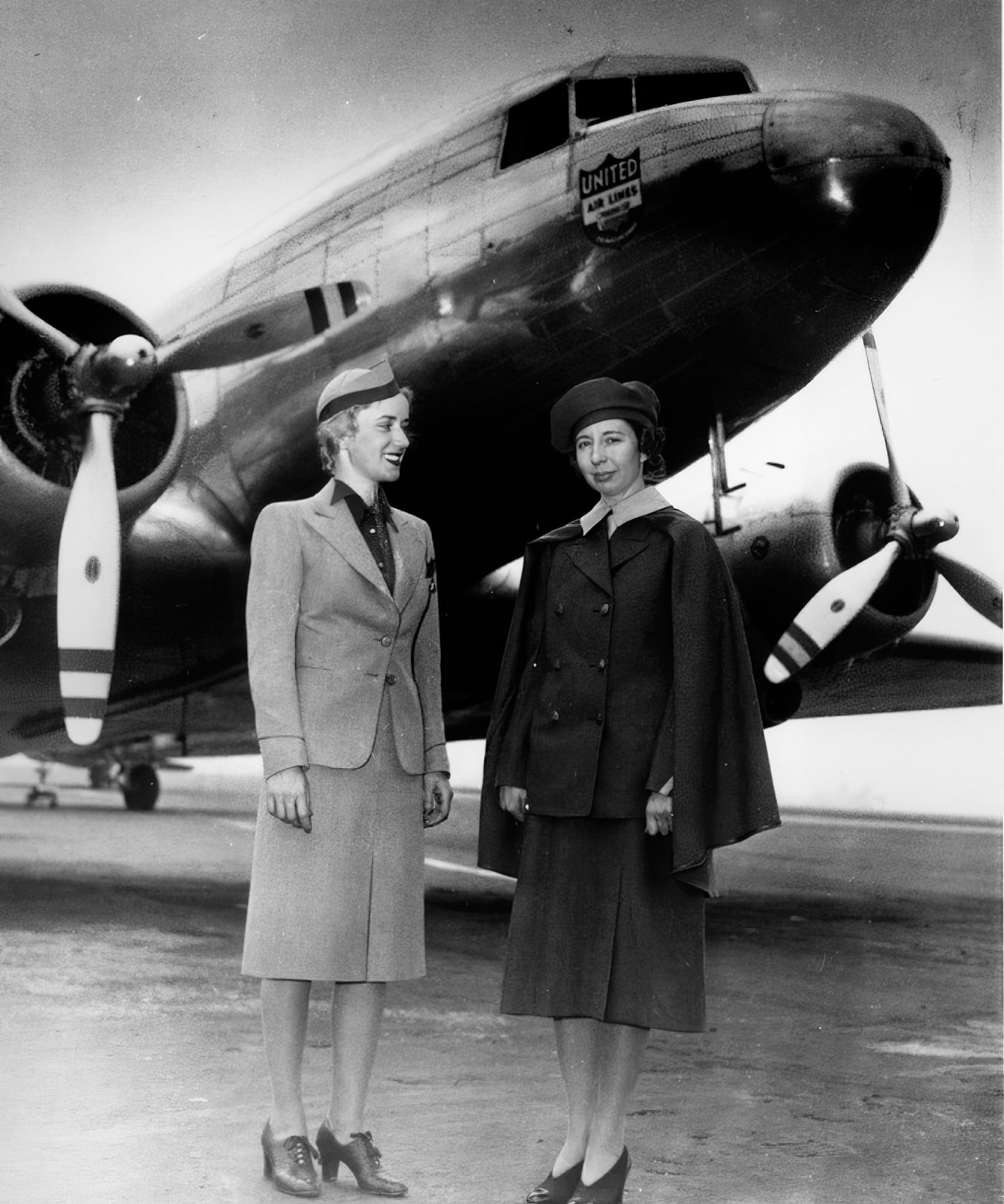 Ellen Church, at right, with a United Air Lines stewardess, poses in front of a Douglas DC-3 Mainliner at Chicago on May 14, 1940.