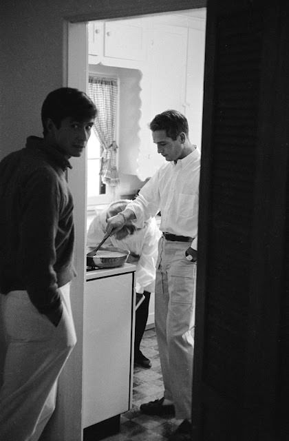 Paul Newman cooking eggs for Anthony Perkins at his Hollywood home, 1958.