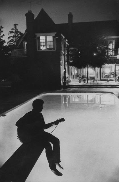 Ricky Nelson playing guitar at his family's Hollywood home, 1958.