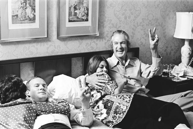 Tommy Smothers, with Rosemary and Timothy Leary, gives the peace sign.