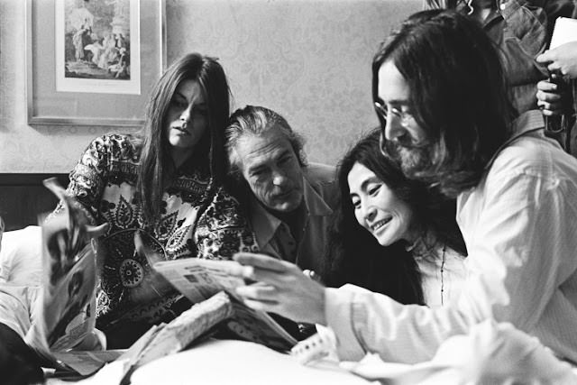 Rosemary and Timothy Leary, with Yoko Ono and John Lennon reading the local paper about their "Bed-In."