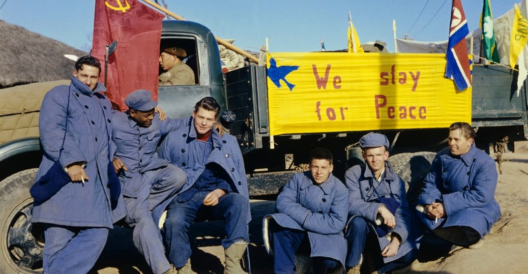 Twenty-one American soldiers refused to return to America at the end of the Korean War. The sign on the truck reads: "We Stay for Peace." They moved to China; by the 1960s, all but two had returned home.