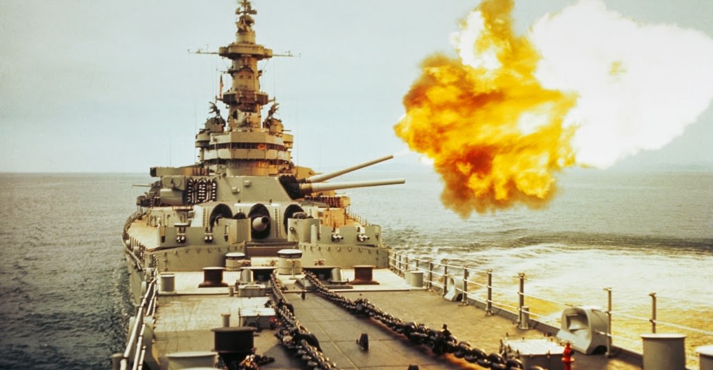 A view from the bows of the USS Missouri as the main batteries (16-inch guns) fire on enemy targets off North Korea.