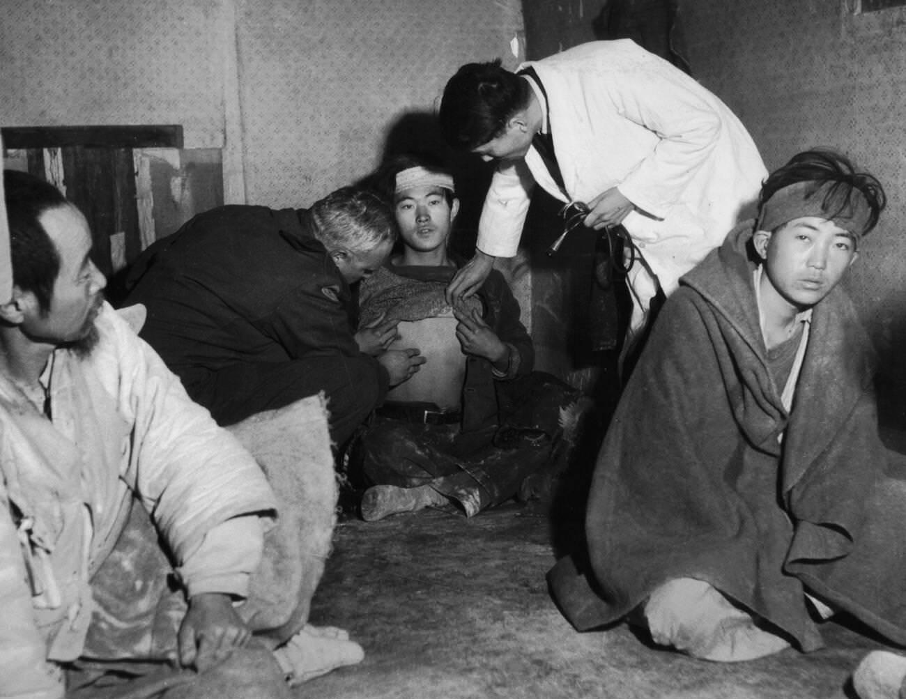 Refugees from Koje island. Doctor Henri Meyer examines a refugee suspected to have contracted typhus, 1951.