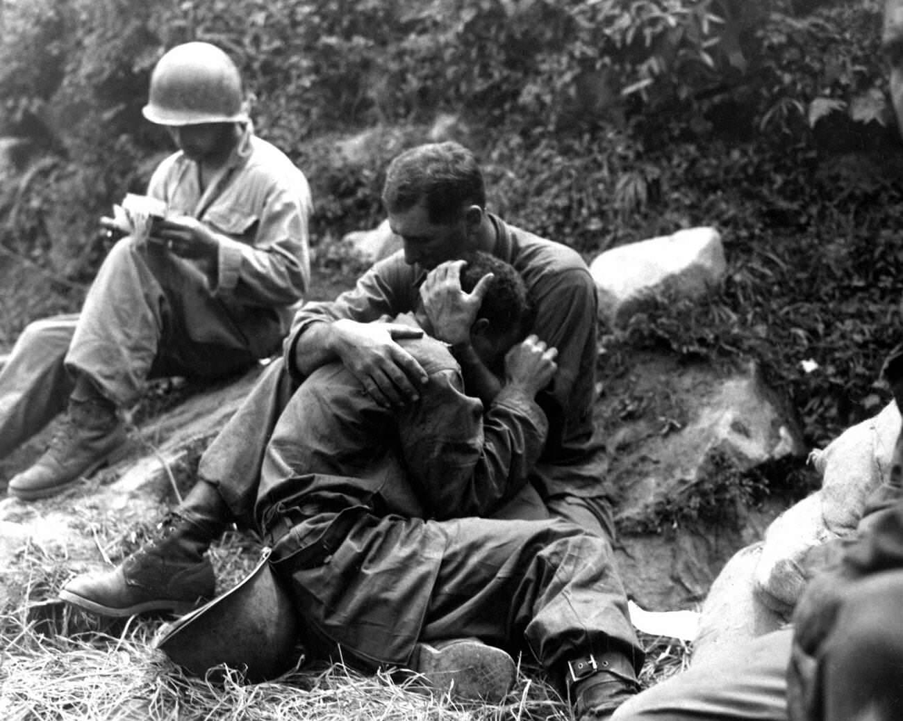 Korean War, American soldier comforts another soldier in distress, 1953.