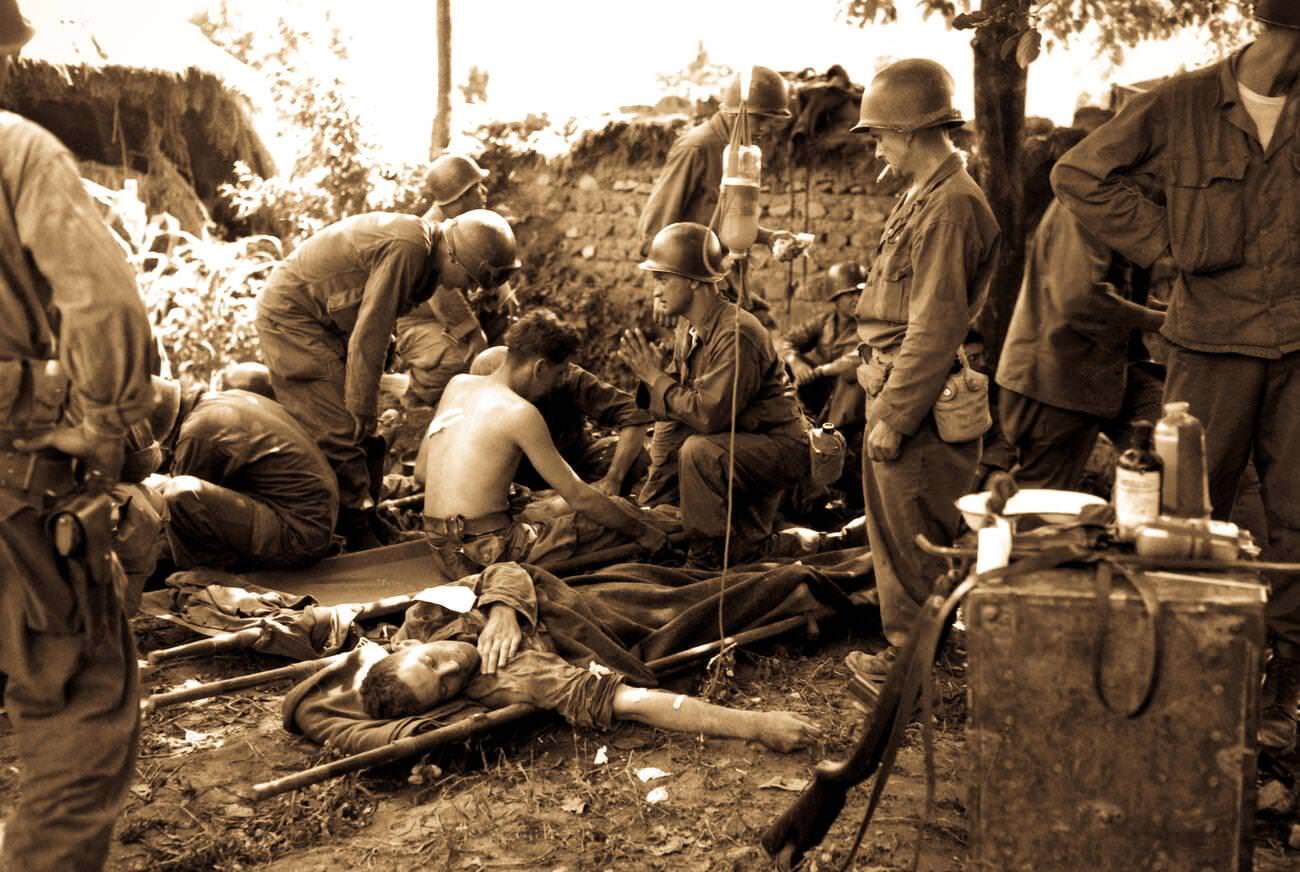 Wounded American soldiers are given medical treatment at a first aid station, 1950s.