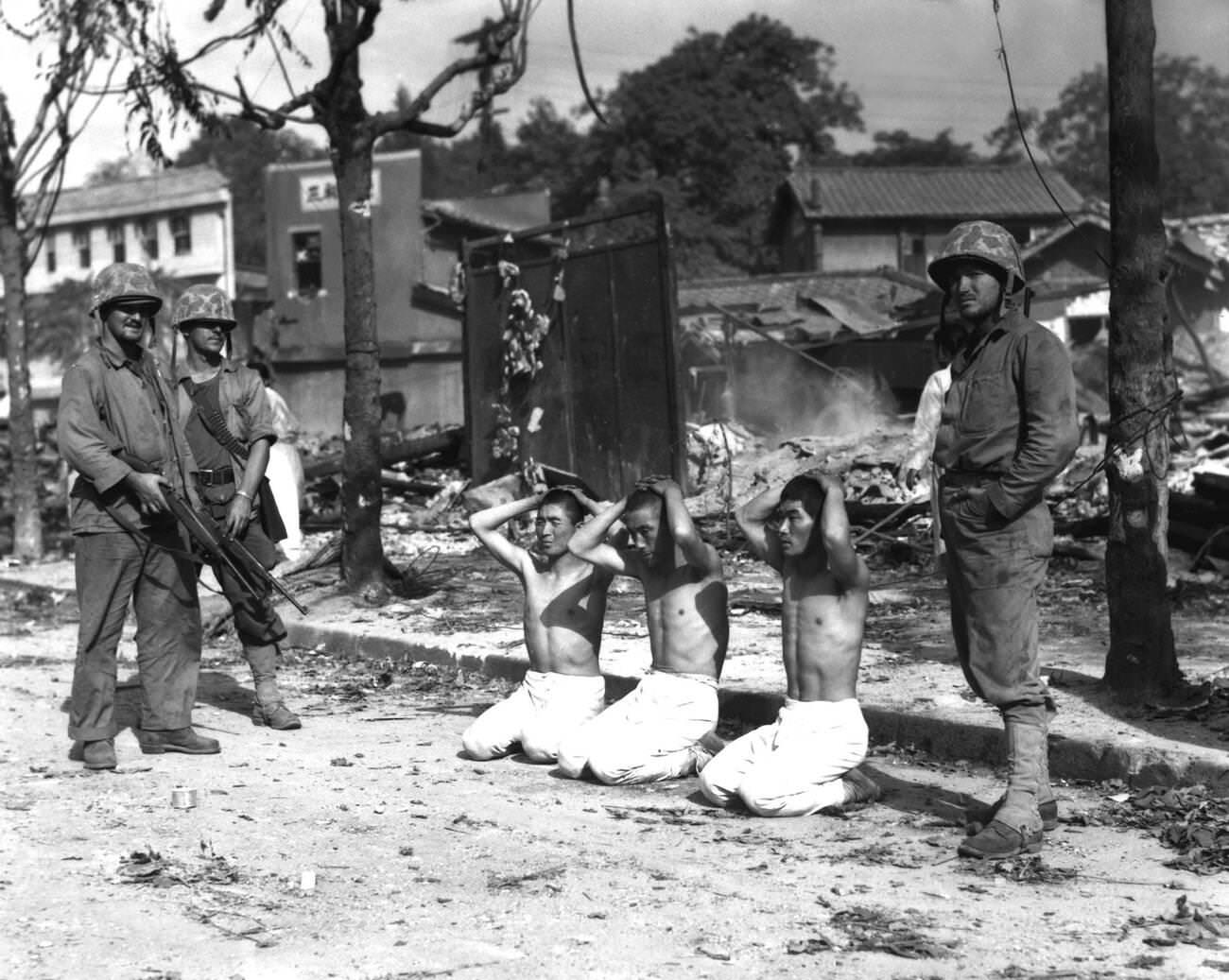 Korean War, U.S. Marines with POWs, 1950.