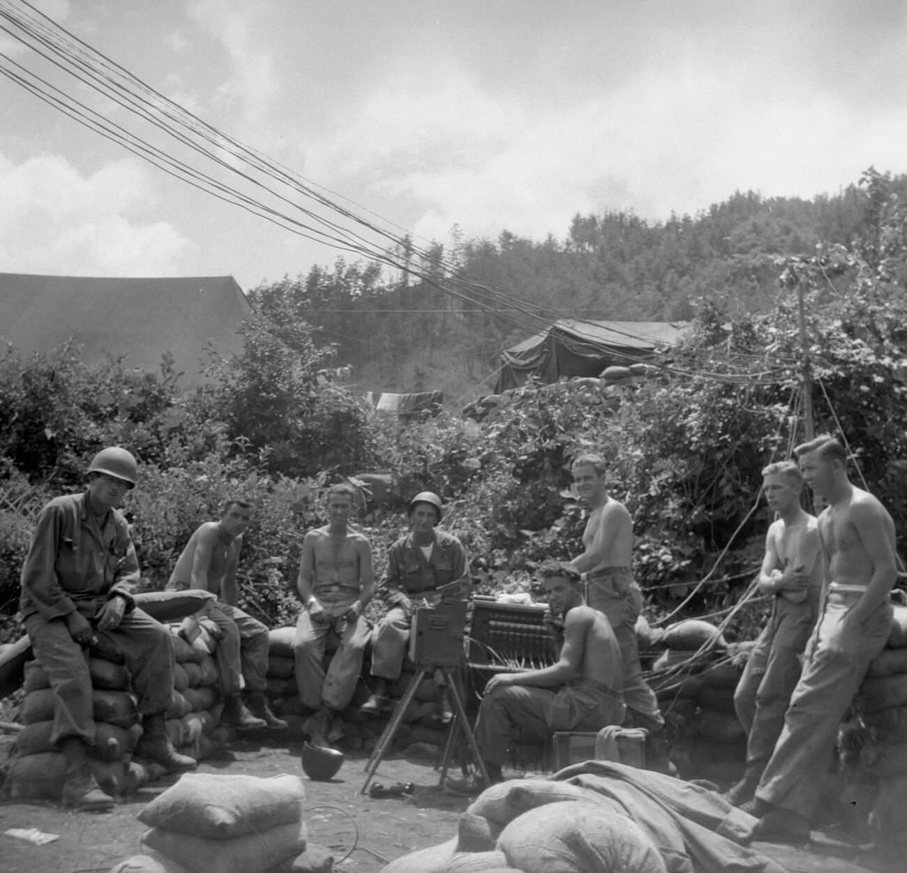 Signalmen and other soldiers fighting with the Second Infantry Division, during the Korean War, relax, 1950s.