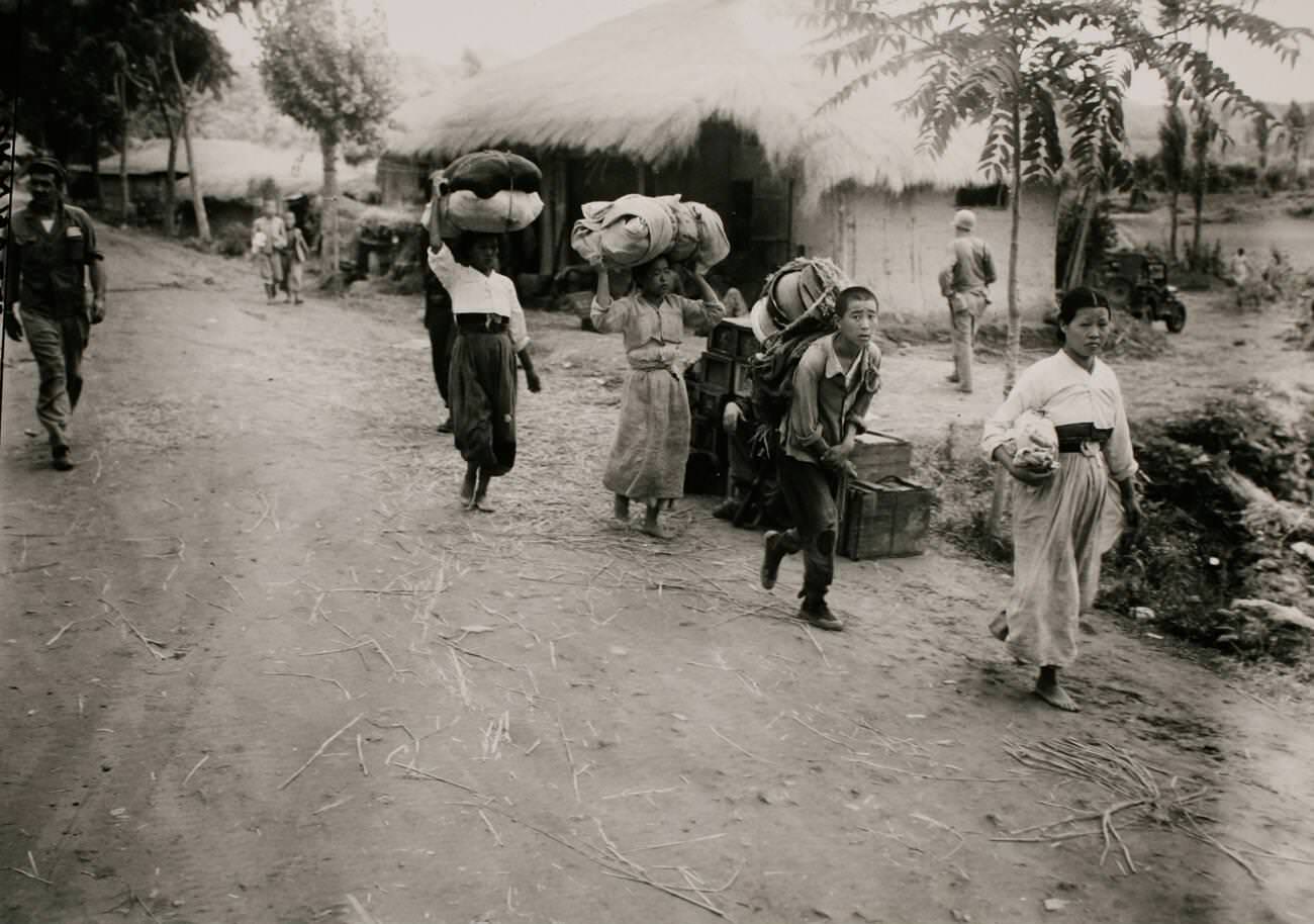 Refugees from the conflict between South Korea and the communist led North Korean invaders flee southward, 1950.