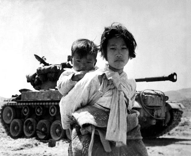 Korean civilians pass an M-46 tank, 1950s.