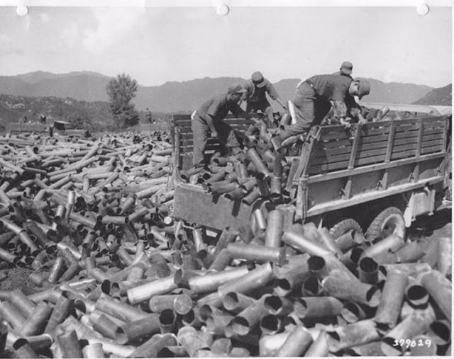 ROK soldiers dump spent artillery casings, 1950s.