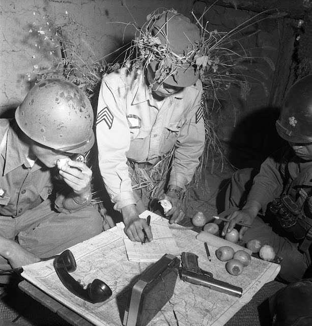 South Korean and American officers pore over maps, 1952.