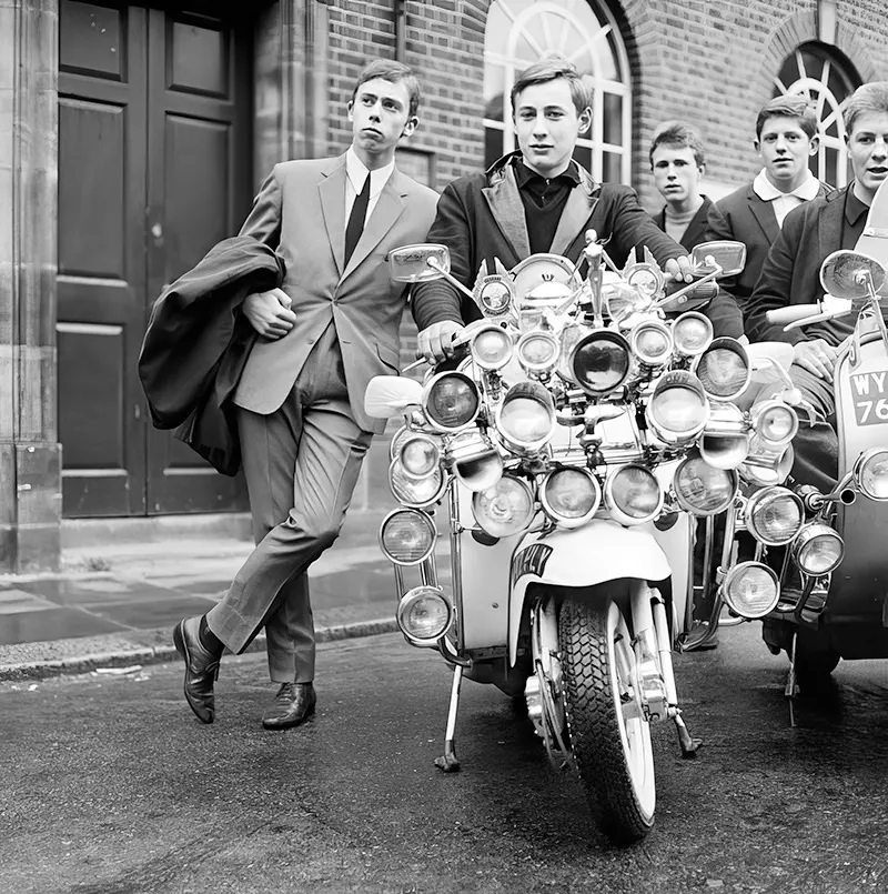 Mods in suits and parkas show off modified scooters in Peckham, England, 1964.