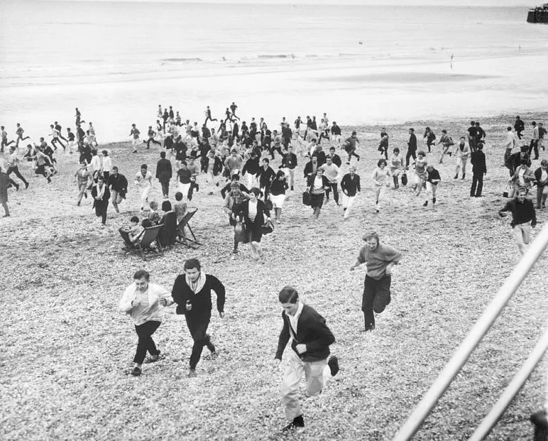 Hundreds of mods and rockers convene on a beach for an all-out brawl in Hastings, England, 1964.