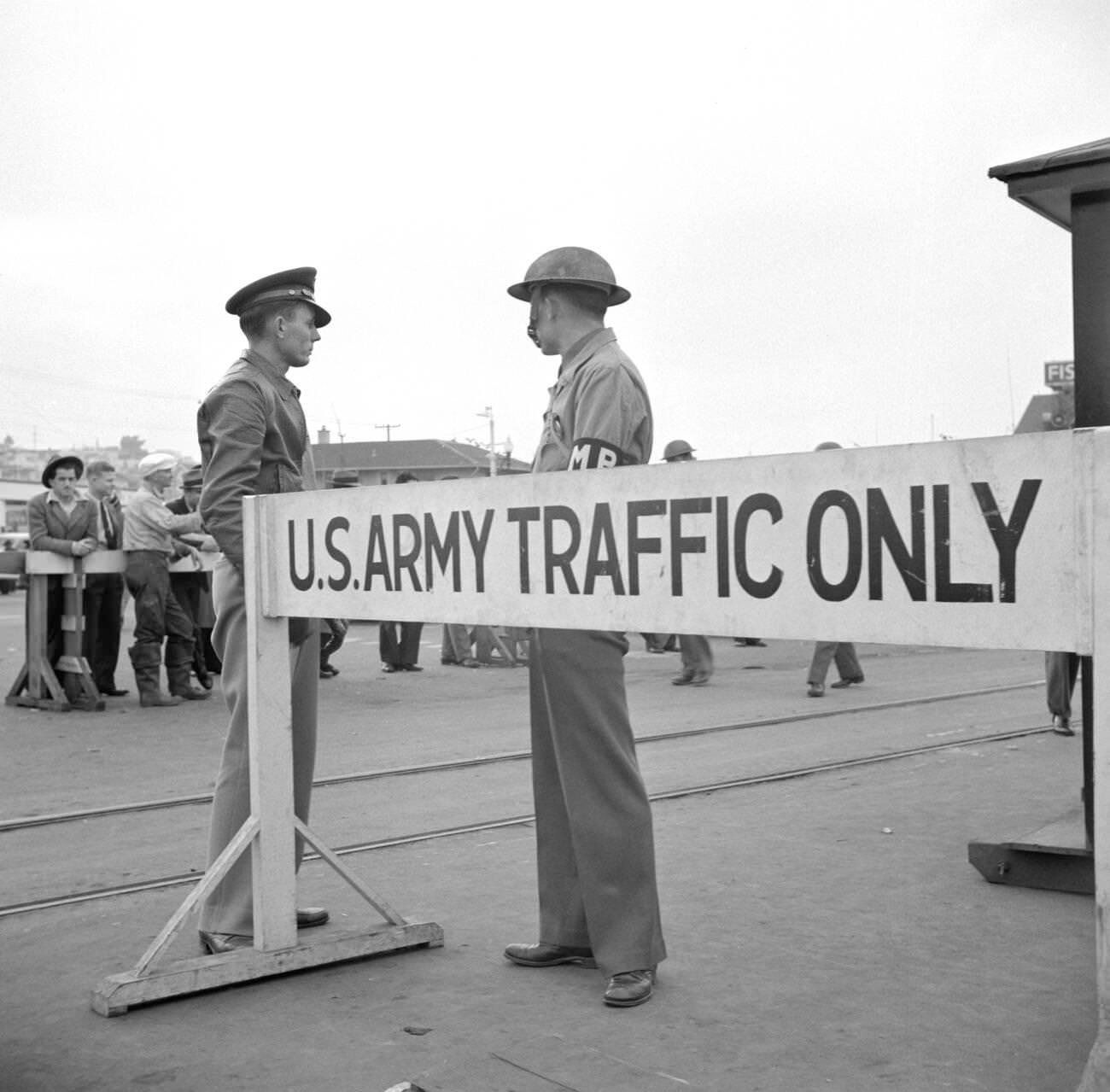 Army sentries standing guard at a transport dock, San Francisco, California, USA, 1941.