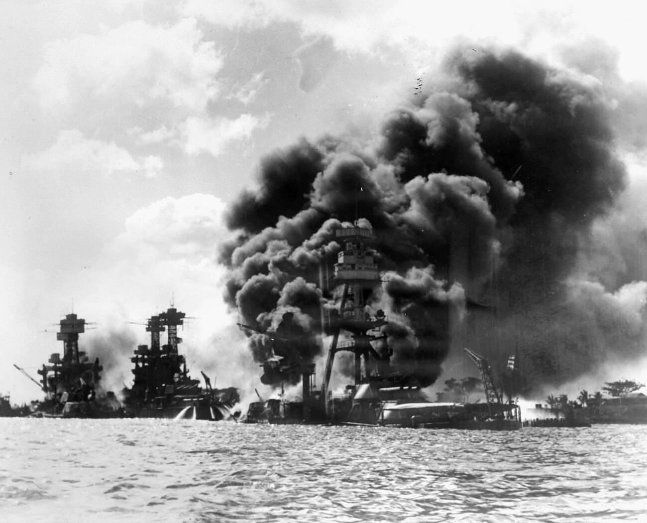 Battleships burning in Pearl Harbor on December 7, 1941, Hawaii, USA. L. to R. USS Arizona, USS Tennessee, and USS West Virginia.