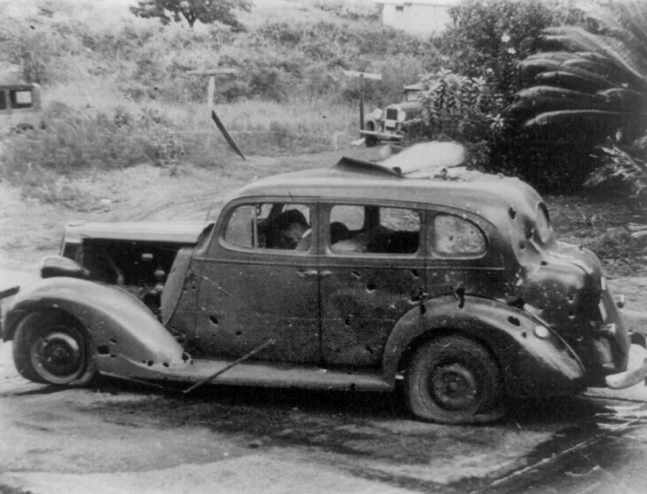 A car with a dead driver at the wheel, Pearl Harbor attack, 1941.