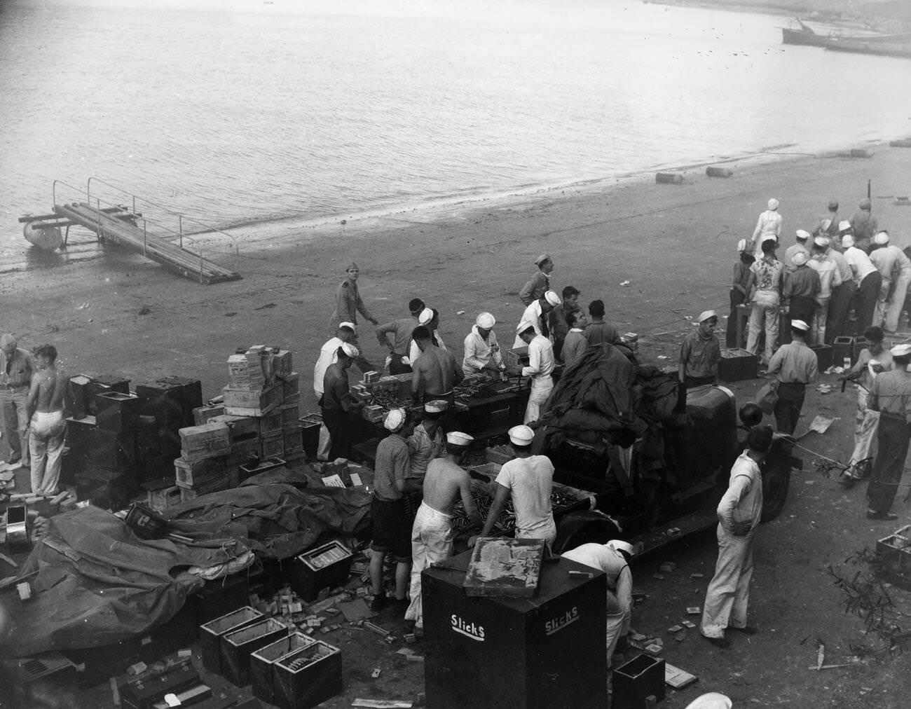 American sailors at Naval Air Station Ford Island reloading ammunition clips and belts during attacks on Pearl Harbor, 1941.