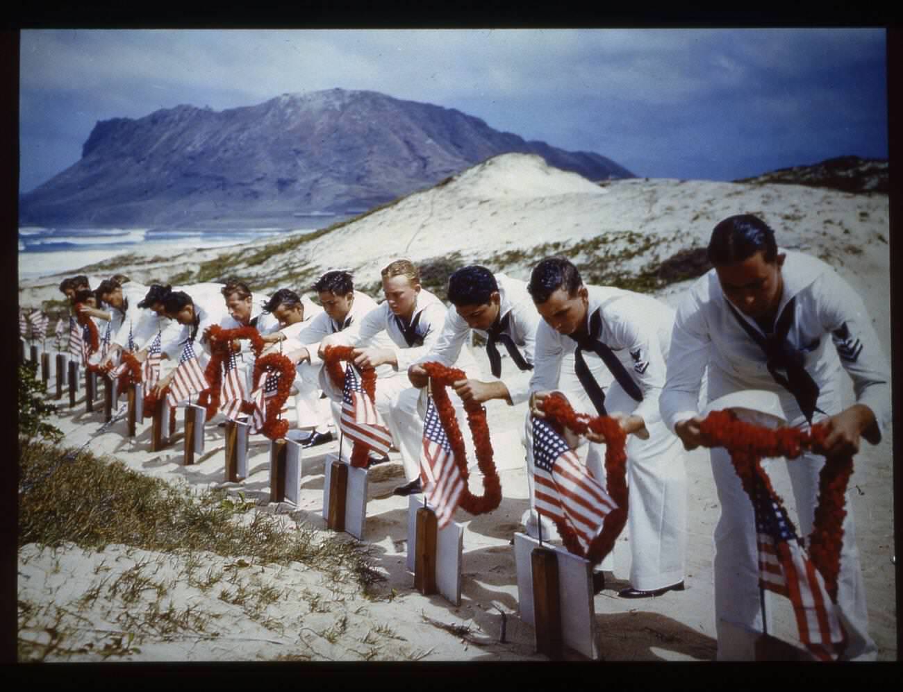 Sailors pay tribute to casualties of the Pearl Harbor attack at a Hawaiian Islands cemetery, 1942.