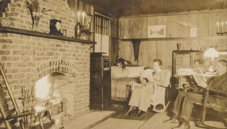 Couple reading books in front of a fireplace