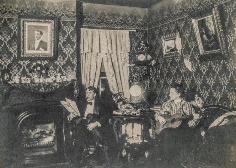 Couple relaxing in the living room with a dog and guitar