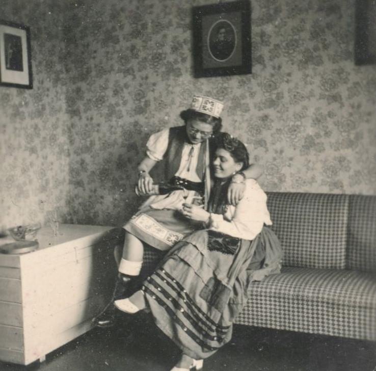 Two German women pouring a glass of wine