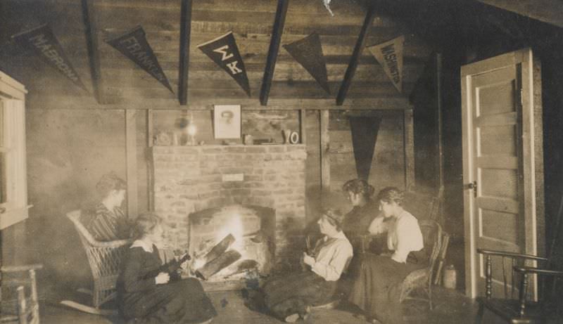 Women gathered around a fireplace playing musical instruments