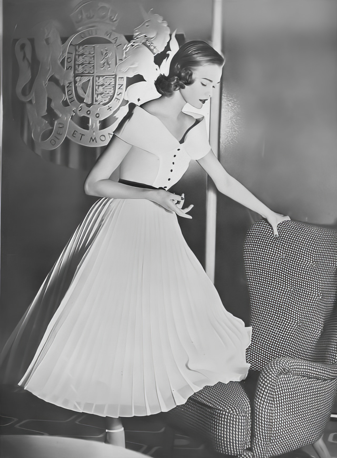 Susan Abraham in a pleated white organza evening dress, 1952.